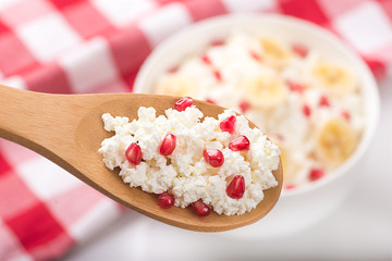 cottage cheese on a  wooden spoon
