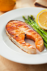 salmon steak with asparagus in plate