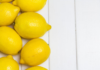 Lemons on a white wooden background