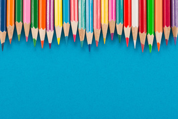 Color pencils on blue background
