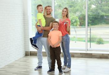 Happy family with house key in new apartment