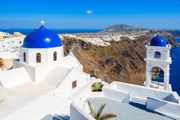 Typical Greek church in Imerovigli village with sea and volcano in background, Santorini island, Greece