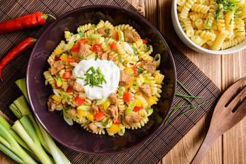Fusilli pasta salad with fried pork, pepper, green onion, parsley and sour cream dressing
