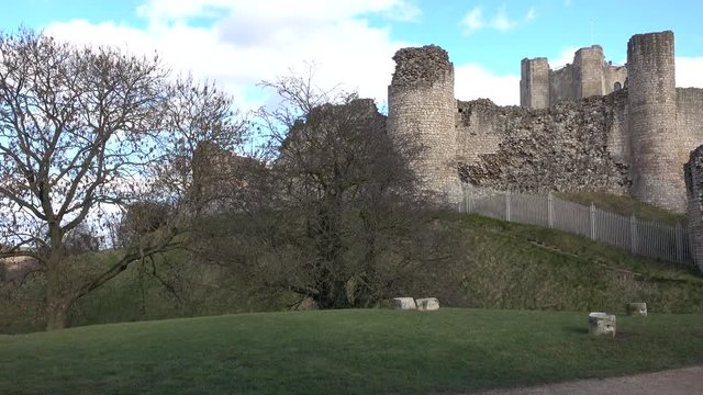 Conisbrough Castle England pan across tower wall. Medieval fortification built in the 11th century. The keep comprises a circular central tower with six massive buttresses.