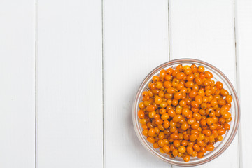 Sea buckthorn on a white wooden background