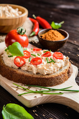 Creamy curd spread with chili, ground cumin, chive and basil