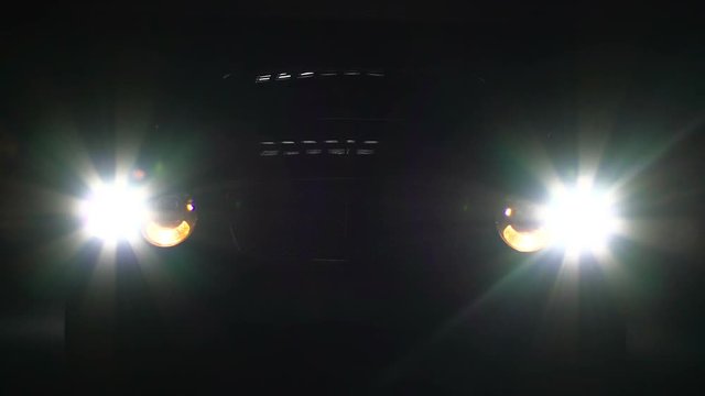 Auto switches on bright headlight, car emerges in darkness suddenly, danger