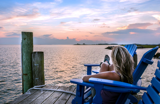 Fototapeta Female enjoying a sunset on a Chesapeake Bay pier