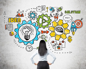 Woman in suit examining concrete wall