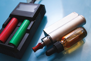 Electronic cigarettes,charger and bottles of liquid.