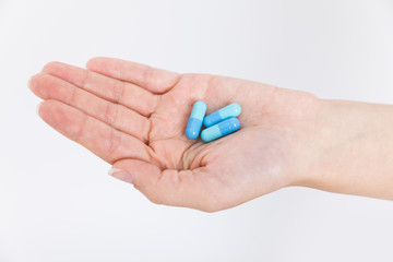 Girl holding pills in her hand