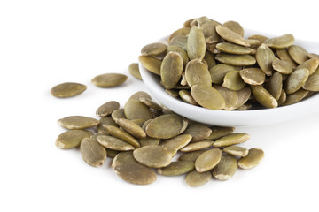 shelled pumpkin seeds isolated on white background