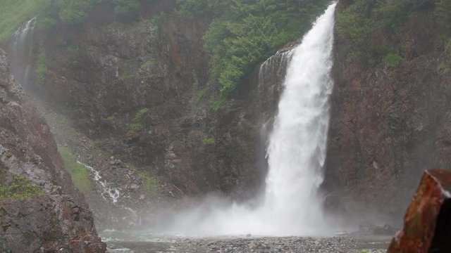 Massive Raging Waterfall Splashing the Ground in Pacific Northwest Forest