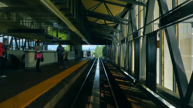 4K Skytrain Subway Train Station, Train Passes Platform, Comes to Stop