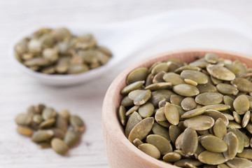 shelled pumpkin seeds isolated on white background