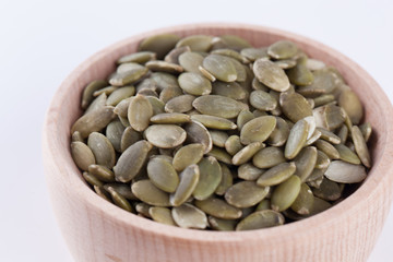 shelled pumpkin seeds isolated on white background