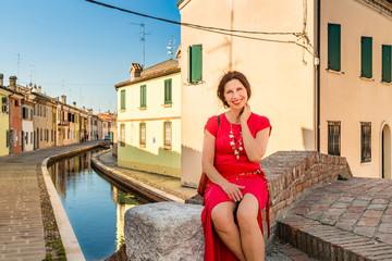 woman sitting on bridge