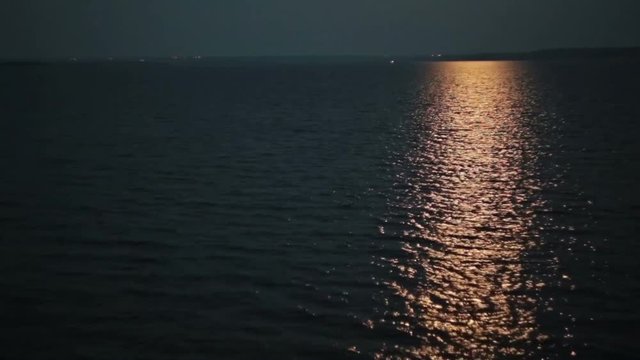 Moonlight path with low fool moon above the river at night