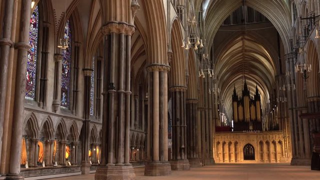 Lincoln England Cathedral pan inside church chapel nave. Roman settlement 48 AD. Cathedral built 1092, once tallest man made structure in the world. Destination for tourists and visitors.