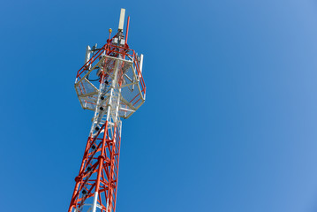 Mobile phone base station tower in blue sky.