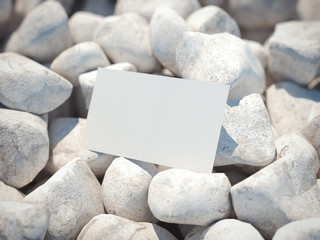 White business card on pebble. 3d rendering