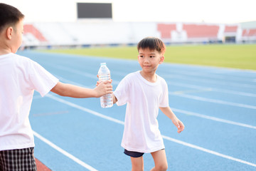 Running boy take water