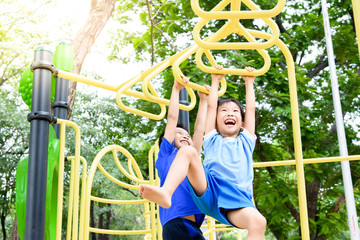 Boy play with hang yellow bar.