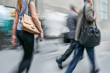 motion blurred business people walking on the street