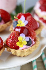 Cupcakes with fresh fruits and edible flowers.