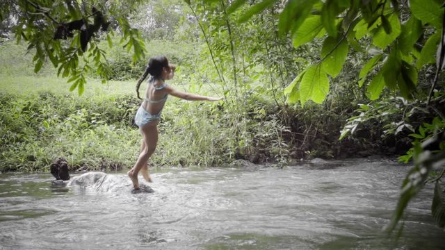 Hispanic Girl Jumping Into The River In A Family Trip On Panama . Slow Motion