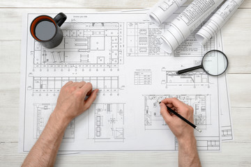 Close-up hands of architect working with a drawing