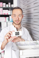 Young pharmacist at medicine cabinet