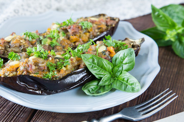 baked eggplant stuffed with vegetables, meat and cheese