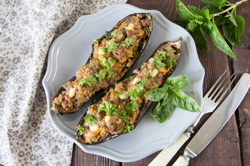 baked eggplant stuffed with vegetables, meat and cheese