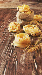 Uncooked pasta with flour on the table, selective focus