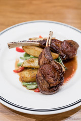 Rack of lamb grilled to perfection served with roasted potatoes, french beans, cherry tomatoes