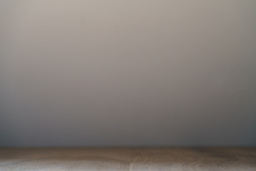 old stained oak wood table and wall background