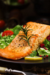 Baked salmon served with fresh vegetables.