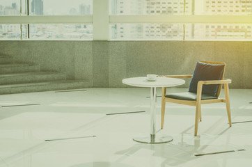 Armchair and table with coffee cup with vintage filter