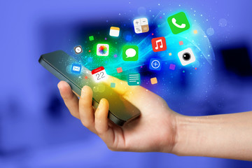 Hand holding smartphone with colorful app icons