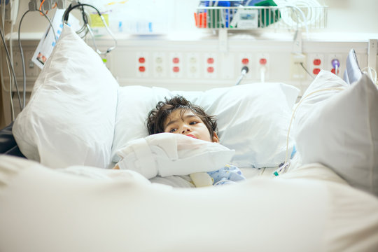 Disabled little boy lying sick in hospital bed