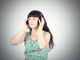 Fototapeta premium Young woman listening to music with headphones