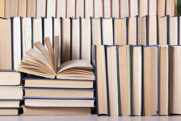 Open book, hardback books on wooden table. Education background. Back to school. Copy space for text.