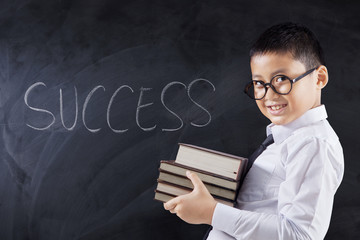 Boy carrying books with text of Success