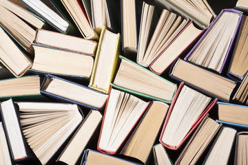 Open book, hardback books on wooden table. Education background. Back to school. Copy space for...