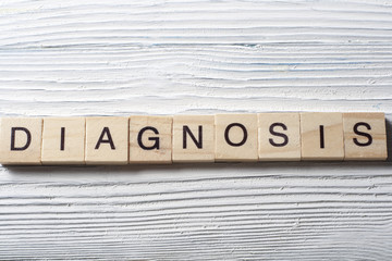 Diagnosis written in wooden cubes on a table.