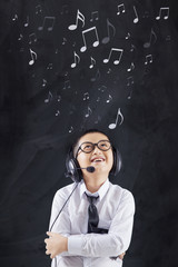 Cheerful boy with headphones in class