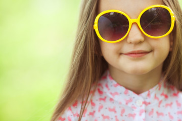 Kids fashion and accessory concept. Portrait of smiling girl in eyewear