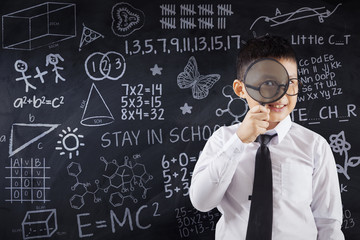 Schoolboy with magnifier and doodles