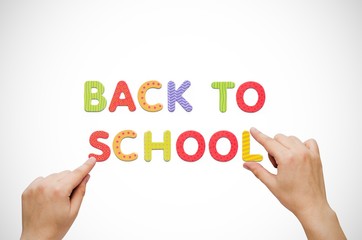 Hand put the words Back To School on magnetic board